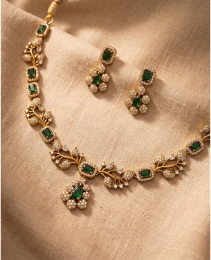 Gold plated emerald green necklace set with leaf vine design, CZ diamonds and matching floral drop earrings