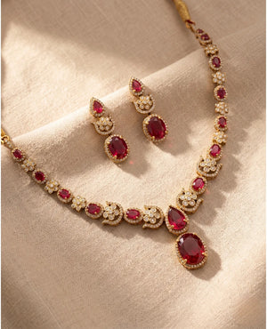 Gold plated ruby red American diamond necklace set with oval stones and matching earrings