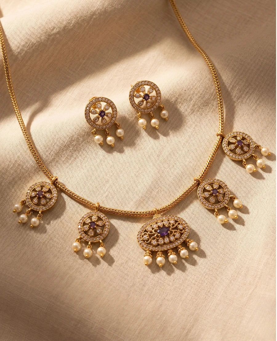 gold-plated-temple-necklace-set-with-purple-stones-pearl-drops-and-matching-earrings-on-woven-chain