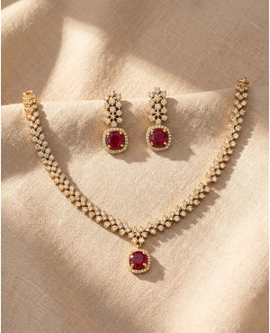 Gold plated necklace set with ruby red oval pendant, American diamonds and matching drop earrings