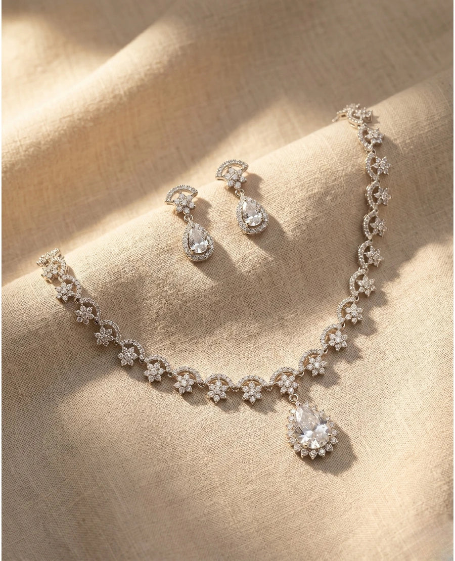 silver-rhodium-plated-necklace-with-american-diamond-floral-design-and-teardrop-pendant-earrings
