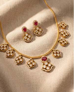 Gold plated temple necklace with ruby red stones and leaf mango pendants with earrings