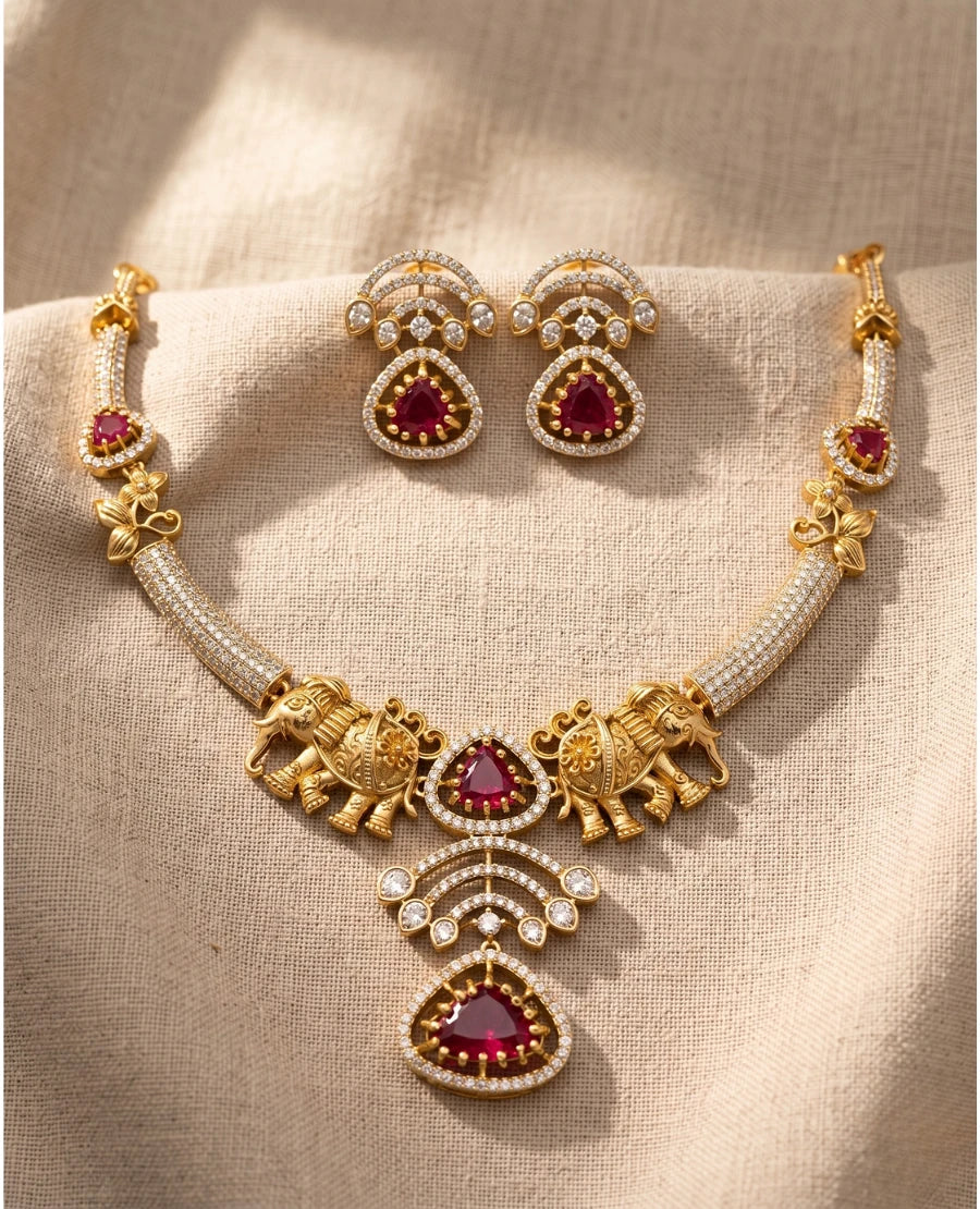 antique-gold-bridal-necklace-with-elephant-motifs-ruby-red-stones-and-layered-pendant-with-earrings
