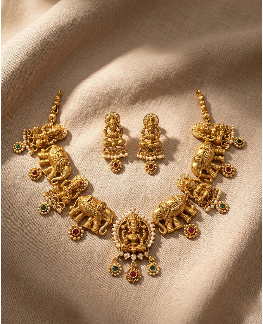 antique-gold-temple-necklace-set-with-lakshmi-and-elephant-motifs-pearls-ruby-emerald-stones