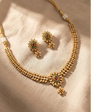 Classic gold plated Polki Kundan choker necklace with ruby green center and matching floral earrings