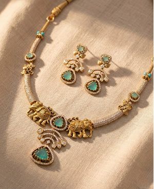 Antique gold elephant hasli necklace set with mint green stones and matching earrings