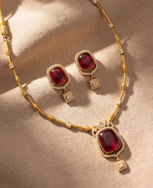 Gold plated ruby red doublet stone pendant necklace set with matching earrings
