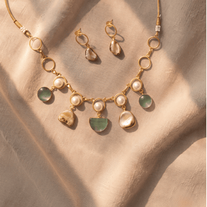 Gold-toned link necklace and matching earrings adorned with white pearls, translucent elements, and rich green-brown Monalisa stones