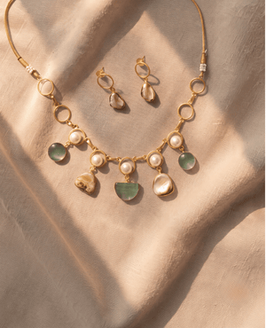 Gold-toned link necklace and matching earrings adorned with white pearls, translucent elements, and rich green-brown Monalisa stones