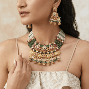 Luxurious uncut diamond Polki bridal set with pearl drops and meenakari work for a traditional wedding look.