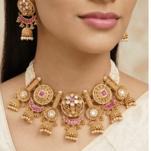 Luxurious uncut diamond Polki bridal set with pearl drops and meenakari work for a traditional wedding look.