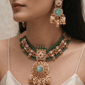 Luxurious uncut diamond Polki bridal set with pearl drops and meenakari work for a traditional wedding look.